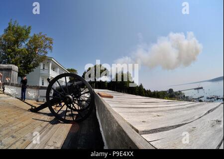 Cannon firing reenactment at Fort Mackinac, 1 of only 2 Revolutionary War Forts remaining in USA, on Mackinac Island on Lake Huron, Michigan, USA Stock Photo