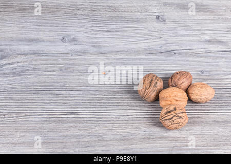 autumn nuts laid on anthracite gray wood in background Stock Photo