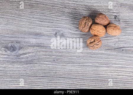autumn nuts laid on anthracite gray wood in background Stock Photo