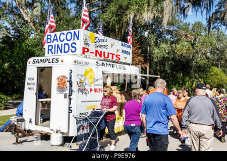Florida,Micanopy,Fall Harvest Festival,annual small town community booths stalls vendors buying selling,food truck trailer,bacon rinds,roasted peanuts Stock Photo