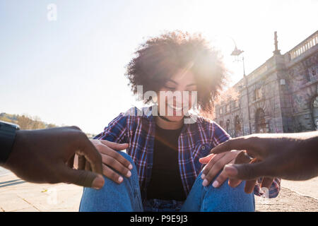 beautiful nice black race ethnic hair gyoung girl have fun with a african man smiling and laughing with him. happy people at the city. backlight and s Stock Photo