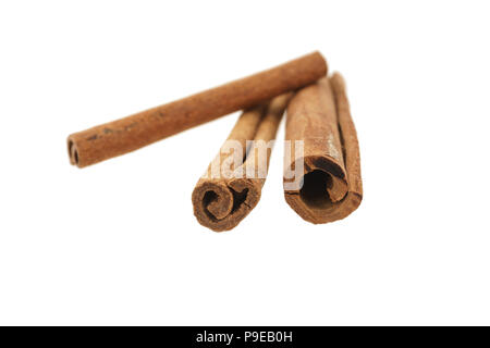 three whole sticks of cinnamon isolated on white background Stock Photo