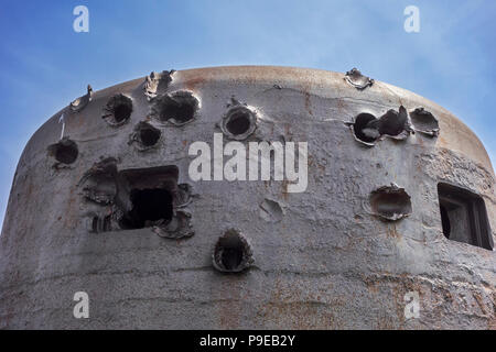 Battle-scarred World War Two 60 ton armoured bell of German coastal battery at D-Day Omaha Museum, Vierville-sur-Mer, Calvados, Normandy, France Stock Photo