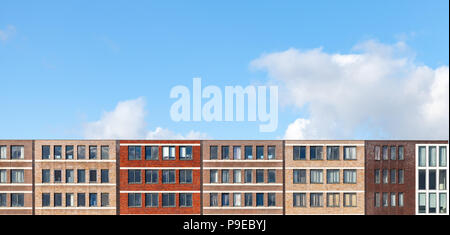 Colorful facades of living houses in a row under blue cloudy sky, Amsterdam, Netherlands Stock Photo