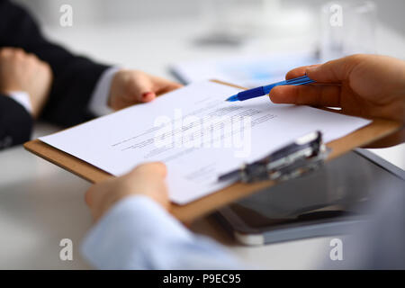 Businesspeople sitting on the desk on office Stock Photo