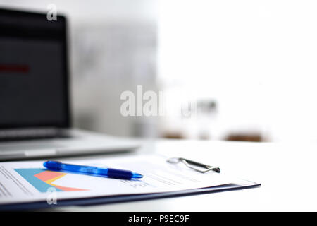 Laptop  computer with folder on  desk  Stock Photo