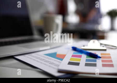 Laptop  computer with folder on  desk  Stock Photo