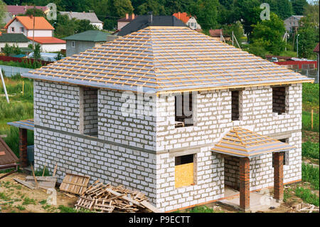 construction of the roof of the house, unfinished house of white brick Stock Photo