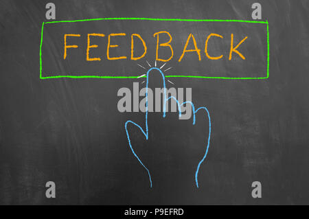 Feedback button and hand cursor colorful chalk drawing on chalkboard or blackboard as contact support service client opinion evaluation concept Stock Photo
