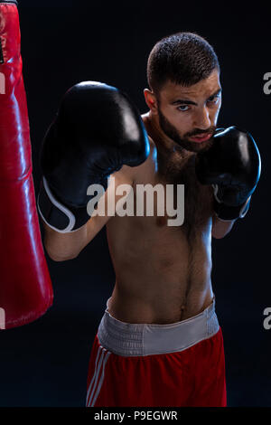 Double arm block. Boxing trainer showing defensive techniques. Combat sport, fight club. Stock Photo