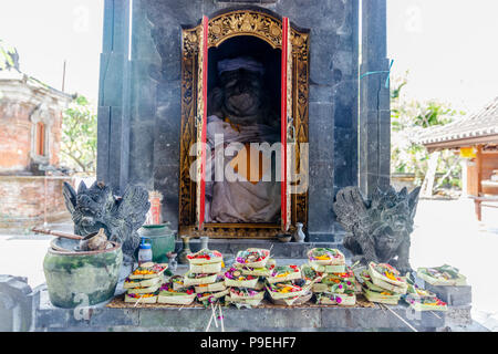 Balinese offerings (canang sari) on altar at Hindu temple in Sanur. Bali, Indonesia. Stock Photo