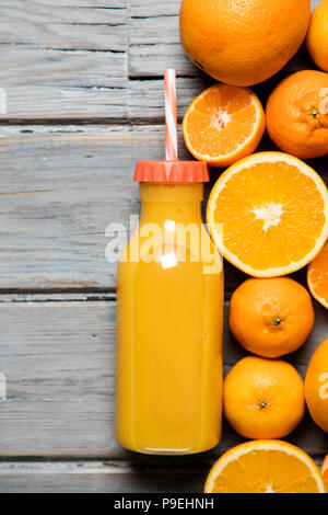 Glass Bottle of Fresh Orange Juice with Fresh Fruits and Flowers Vase on  Wooden Planks Table Stock Photo - Image of fruit, fresh: 239025358