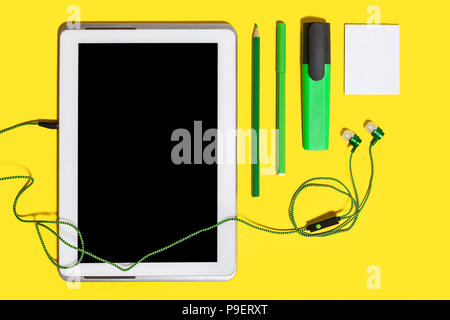 office chancery and gadgets on a yellow surface Stock Photo