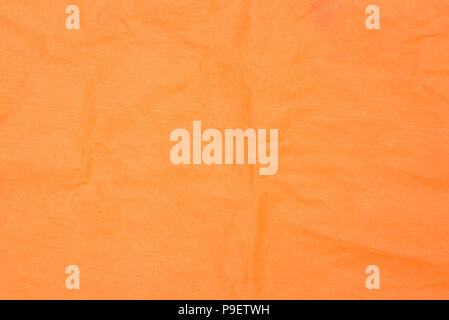 orange color creased tissue paper background texture Stock Photo