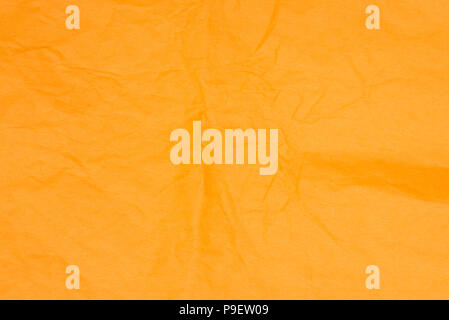 orange color creased tissue paper background texture Stock Photo