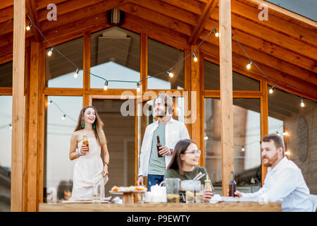 Friends dining on the backyard of the house Stock Photo