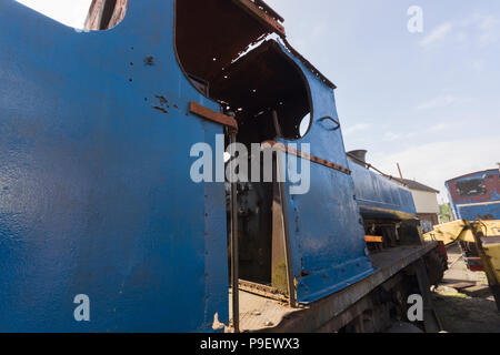 A derelict and rusting steam engine at the Cambrian Heritage Railway museum in Oswestry UK Stock Photo