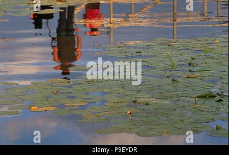 12 July 2018, Germany, Fuessen: Daytrippers are reflected on the water of Hopfensee lake. Photo: Karl-Josef Hildenbrand/dpa Stock Photo