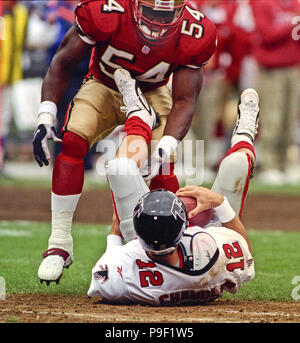 Atlanta Falcons quarterback Chris Chandler (12) is sacked by Denver Broncos  linebacker Bill Romanowski (53) during the first quarter of Super Bowl  XXXIII in Miami, Sunday, Jan 31, 1999. (AP Photo/Doug Mills