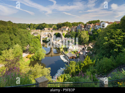 Knaresborough, UK. 18th July 2018. A riverside view of Knaresborough, rowing boats moored, and the four span stone arched viaduct over the River Nidd in lower Nidderdale on a mid-summer sunny day. Credit: John Potter/Alamy Live News Stock Photo