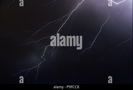 Night sky illuminated by lightning bolts Stock Photo