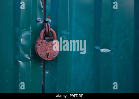 Background photo of old rusty keylock and closed gates for design of advertisement promo Stock Photo