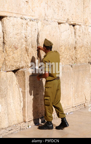 Israeli man soldier praying at The Western Wall the Kotel , Jerusalem, Israel Stock Photo