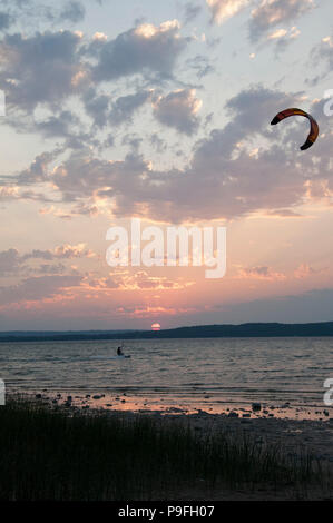 Kite surfing as the sun sets on Grand Traverse Bay in Traverse City, Michigan. Stock Photo