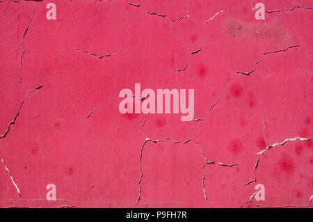 Old dirty stained grunge weathered red painted plastered house wall surface closeup as background Stock Photo