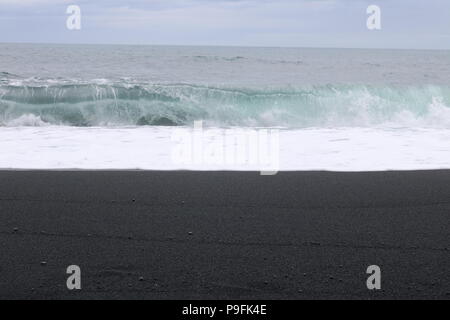 Rolling waves on black beach by Reynisfjara, Iceland Stock Photo