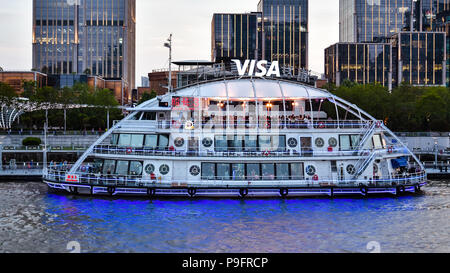 Shanghai, China - Apr. 24, 2018: Cruise boat on Huangpu River, taking tourists to view landmark high rises in new Pudong district, Shanghai, China. Stock Photo