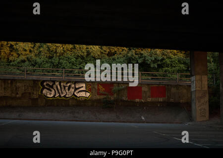 Urban decay - Graffiti paint sprayed under walls of flyover in Essex, Britain. Stock Photo