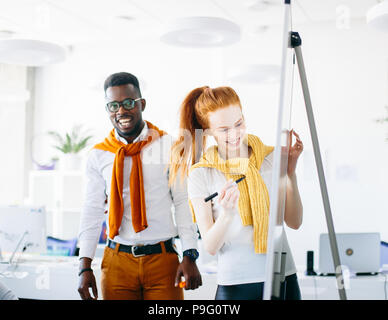 two artists drawing on flipchart in the modern studio Stock Photo