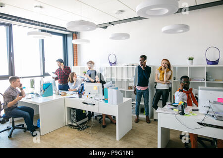 mobile phone addiction. working young hipsters are spending time on mobile phones. Stock Photo