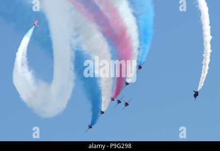 Torbay Airshow, Devon, England: The RAF Red Arrows display team flies in a tight arrowhead formation trailing red, white and blue smoke Stock Photo