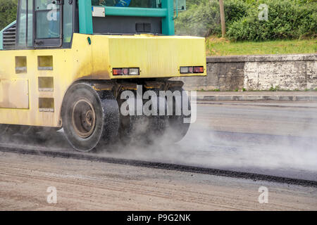 Close view on the working road roller. Street paving works Stock Photo