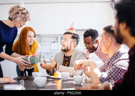 mixed race colleagues celebrating a birthday in the office kitchen. closeup portrait Stock Photo