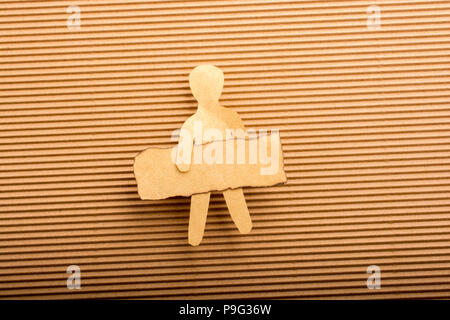 Paper man shape holding burnt note paper in hand Stock Photo