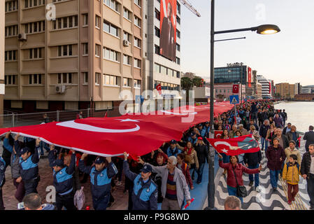 Izmir, Turkey - October 29, 2017: People walking at Kordon Konak Izmir with a huge Turkish flag and holding their Turkish flags on hands and some with Stock Photo