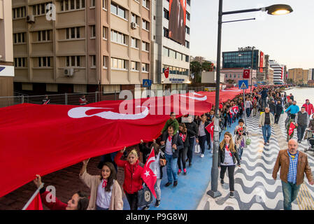 Izmir, Turkey - October 29, 2017: People walking at Kordon Konak Izmir with a huge Turkish flag and holding their Turkish flags on hands and some with Stock Photo