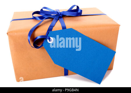 Plain brown paper package or parcel, blue gift tag or label and ribbon isolated on white background, side view Stock Photo