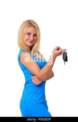 the girl in the blue dress holds the car keys on white background, car rent or sale Stock Photo
