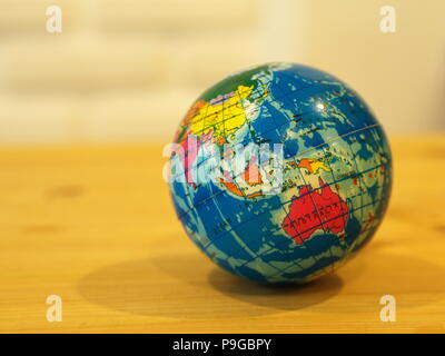 Close Up Mini Globe with Wooden Table Background Stock Photo