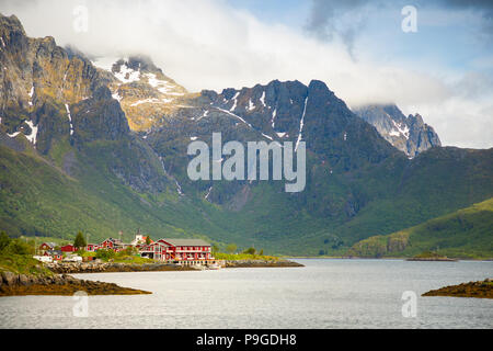 Tipical red fishing houses on fjord, Lofoten islands, Norway Stock Photo
