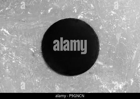 Black empty round slate plate on stone gray background. top view. Stock Photo