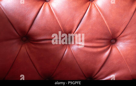 Detailed texture of creased brown leather padding upholstery, background Stock Photo