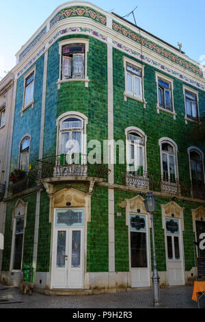 The jade green azulejos tiled facade of the toy shop Loja Obrigado in the Praça Luís de Camões, Lagos Portugal Stock Photo