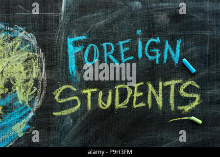 Foreign students exchange program concept with handwritten text in chalk on school blackboard Stock Photo