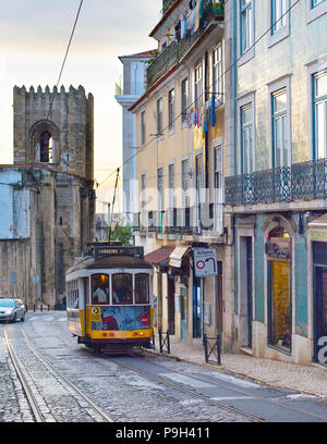 LISBON, PORTUGAL - DEC 07, 2016: Tram 28 on Alfama street. Alfama district is the Old Town of Lisbon, famous tourist attraction. Stock Photo