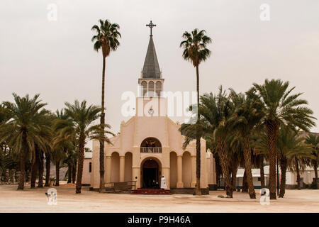 A nun standing at the door of the Roman Catholic Pella Mission Church or Cathedral in Namaqualand, Northern Cape, South Africa. Stock Photo